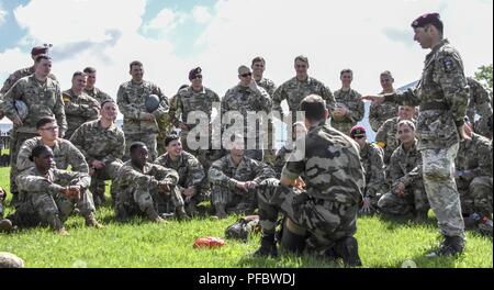 Dutch Jumpmasters instruct paratroopers from the 173rd and across Europe on the proper techniques for their airborne equipment as they prepare for a commemorative jump in Normandy France. Stock Photo