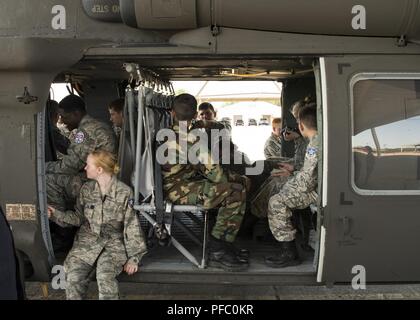 Civil Air Patrol cadets explore a UH-60 Blackhawk helicopter attached to Alpha Company, 2nd Battalion, 149th Aviation Regiment, Arkansas National Guard, June 6, 2018, at Ebbing ANG Base, Ark. Civil Air Patrol cadets from several states visited Ebbing to learn about the 188th Wing’s mission and opportunities in the Air National Guard as part of their summer encampment. Stock Photo