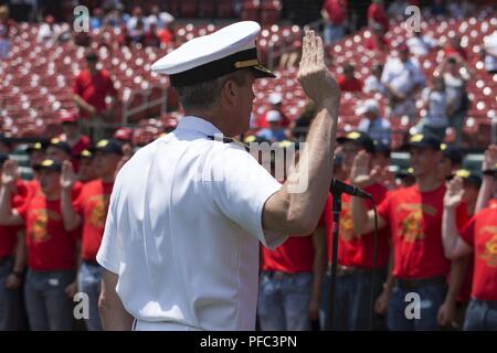 ST. LOUIS (June 7, 2018) – Rear Adm. Pete Garvin, commander, Navy Recruiting Command, administers the oath of enlistment to 80 future Sailors assigned to the 60th Cardinal Division during a pre-game ceremony at Busch Stadium. The division is named after the St. Louis Cardinals who have sponsored such groups annually since 1958. Stock Photo