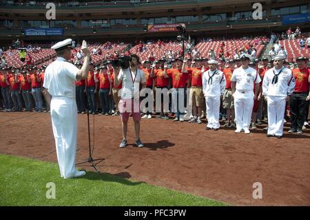 ST. LOUIS (June 7, 2018) – Rear Adm. Pete Garvin, commander, Navy Recruiting Command, administers the oath of enlistment to 80 future Sailors assigned to the 60th Cardinal Division during a pre-game ceremony at Busch Stadium. The division is named after the St. Louis Cardinals who have sponsored such groups annually since 1958. Stock Photo