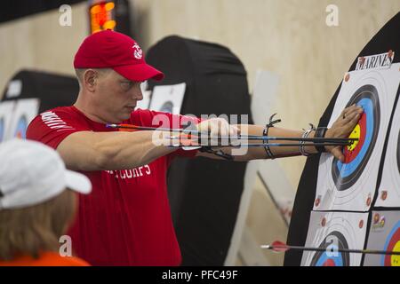 U.S. Marine Corps Sgt. Mark Monroe, a native of Marlborough, Massachusetts, retrieves his arrows at the 2018 DoD Warrior Games Archery Competition at the Air Force Academy in Colorado Springs, Colorado, June 7, 2018. The Warrior Games is an adaptive sports competition for wounded, ill and injured service members and veterans. Approximately 300 athletes representing teams from the Marine Corps, Navy, Army, Air Force, Special Operations Command, United Kingdom Armed Forces, Canadian Armed Forces, and the Australian Defence Force will compete June 1 - June 9 in archery, cycling, track, field, sho Stock Photo