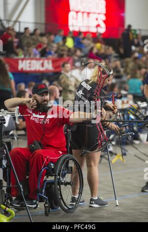 U.S. Marine Corps veteran Douglas Godfrey Jr., a native of Woodbridge, Virginia, releases an arrow at the 2018 DoD Warrior Games Archery Competition at the Air Force Academy in Colorado Springs, Colorado, June 7, 2018. The Warrior Games is an adaptive sports competition for wounded, ill and injured service members and veterans. Approximately 300 athletes representing teams from the Marine Corps, Navy, Army, Air Force, Special Operations Command, United Kingdom Armed Forces, Canadian Armed Forces, and the Australian Defence Force will compete June 1 - June 9 in archery, cycling, track, field, s Stock Photo
