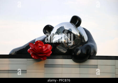 Chongqin, Chongqin, China. 21st Aug, 2018. Chongqing, CHINA-The sculpture of a giant panda holding camellia flowers on the roof can be seen at the artistic installation of 'LOVE.FOUND.' in southwest China's Chongqing. The art installation is designed by Italian artist Simone Carena and Chinese Xu Yihong. Credit: SIPA Asia/ZUMA Wire/Alamy Live News Stock Photo