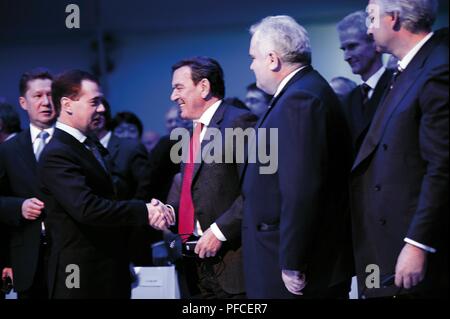 Russia. 21st Aug, 2018. Russian President Dmitry Medvedev shakes hands with Gerhard Schrder, Chairman of the Shareholders' Committee and former Chancellor of the Federal Republic of Germany. (from left to right) Alexei Miller, Deputy Chairman of the Board of Directors and Chairman of the Management Committee of OAO Gazprom, Matthias Warnig, Managing Director Nord Stream and Dr. Johannes Teyssen, Vice Chairman and Chief Operating Officer of E.ON Ruhrgas AG at Nord Stream's start of construction celebration in Portovaya Bay Credit: Nord Stream Ag/Russian Look/ZUMA Wire/Alamy Live News Stock Photo