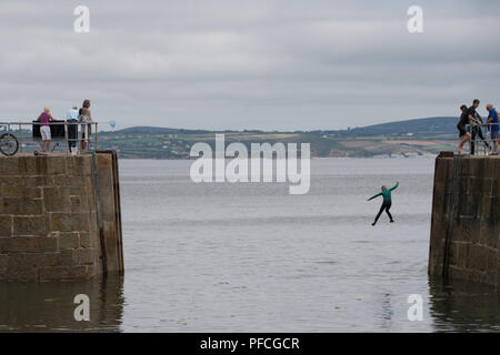 Mousehole, Cornwall, UK. 21st Aug, 2018. UK Weather. Warm but still overcast at Mousehole this afternoon, with people making the most of the sheltered waters in he harbour. Credit: Simon Maycock/Alamy Live News Stock Photo
