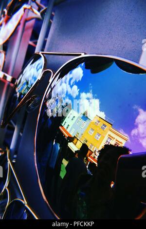 London, UK. 21st August, 2018. 21/08/2018. Camden Town. London. UK. Warm weather in London showing a reflection in sunglasses of some brightly coloured buildings and blue sky with clouds Credit: Sport In Pictures/Alamy Live News Stock Photo