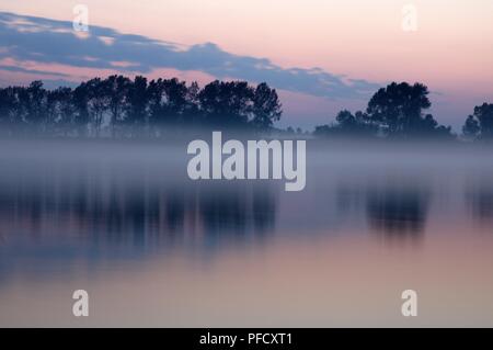 Misty sunset on the Yenisei river. Stock Photo
