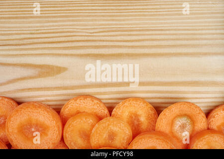 Frame of fresh vegetables around cutting board on wooden ...