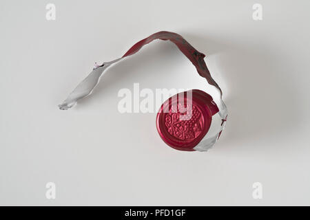 Foil unwrapped from top of wine bottle, close-up Stock Photo