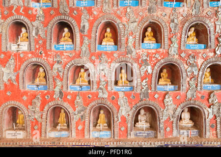 Wall with small Buddhas and leaded glass figures, Shwe Yaunghwe Kyaung Monastery, Nyaungshwe, Inle Lake, Myanmar Stock Photo