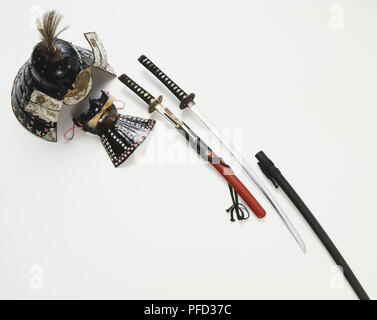 Collection of Samurai artefacts, including a helmet, mask, and a pair of swords Stock Photo