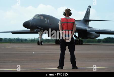 U.S. Air Force Airman 1st Class Daniel Copeland, 345th Expeditionary Bomb Squadron B-1B Lancer crew chief, prepares to marshal the aircraft for takeoff during exercise Trojan Footprint at RAF Fairford, England, June 1, 2018. Trojan Footprint 18 is a U.S. Special Operations Command Europe-led exercise over land, sea and air that rapidly deployed 2,000 NATO and partner nation Special Operations Forces from 13 nations to the Baltic region. Stock Photo