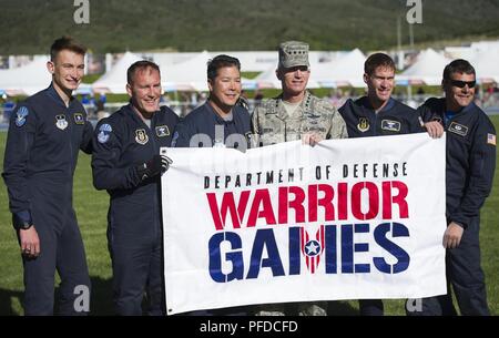 U.S. Air Force Gen. Paul J. Selva, Vice Chairman of the Joint Chiefs of Staff, poses for a picture with the Air Force Wings of Blue Parachute team holding the Warrior Games flag, June 2, 2018, at the DoD Warrior Games. The Warrior Games, taking place June 1-9, 2018, at the U.S. Air Force Academy in Colorado, are a Paralympic-style competition for wounded, and injured service members from all U.S. branches of service and this year include teams from the United Kingdom Armed Forces, Australian Defence Force and Canadian Armed Forces. Stock Photo