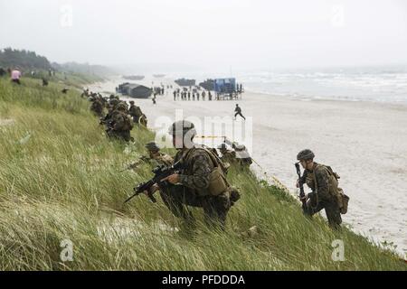 NEMERSITA, Lithuania (June 4, 2018) U.S. Marines and Sailors assigned to Fox Company, Battalion Landing Team, 2nd Battalion, 6th Marine Regiment, 26th Marine Expeditionary Unit, execute a multilateral amphibious landing during exercise Baltic Operations (BALTOPS) 2018 in Nemersita, Lithuania, June 4. BALTOPS is the premier annual maritime-focused exercise in the Baltic region and one of the largest exercises in Northern Europe enhancing flexibility and interoperability among allied and partner nations. (Marine Corps Stock Photo