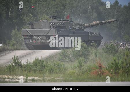 An Austrian Leopard 2A4 tank, operated by Austrian soldiers assigned to 6th Tank Company, 14th Panzer Battalion, fires at its target during the Strong Europe Tank Challenge (SETC), at the 7th Army Training Command's Grafenwoehr Training Area, Grafenwoehr, Germany, June 04, 2018. U.S. Army Europe and the German Army co-host the third Strong Europe Tank Challenge at Grafenwoehr Training Area, June 3 – 8, 2018. The Strong Europe Tank Challenge is an annual training event designed to give participating nations a dynamic, productive and fun environment in which to foster military partnerships, form Stock Photo