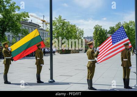 Service members from the United States, Lithuania and several other nations participate in a ceremony to celebrate the 25th Anniversary of the Lithuanian and Pennsylvania Army National Guard’s participation in the State Partnership Program (SPP) in downtown Vilnius, Lithuania, June 10, 2018. The SPP, allows the National Guard to strengthen international relationships while conducting military-to-military engagements in support of defense security goals across the world. Stock Photo