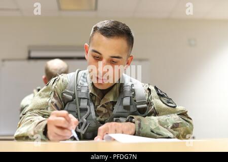 U.S. Army Reserve Spc. Nicolas Cholula, a public affairs specialist representing the 311th Signal Command Theater Support Unit, competes in map reading test at the 2018 U.S. Army Reserve Best Warrior Competition at Fort Bragg, North Carolina, June 10, 2018. Thirty six competitors representing U.S Army Reserve commands throughout the world are vying for the noncommissioned officer and junior enlisted U.S. Army Reserve Best Warrior titles. Stock Photo