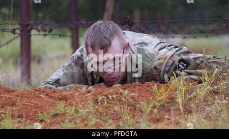 U.S. Army Reserve Sgt. Taylor Nelson, representing 335th Signal Command (Theatre)  completes low crawl obstacle at the obstacle course event as part of the 2018 U.S. Army Reserve Best Warrior Competition at Fort Bragg, North Carolina, June 12, 2018. The grueling, multifaceted competition evaluated U.S. Army Reserve Soldiers in the ruck march, the Excellence in Competition pistol range, the German Armed Forces Proficiency Badge and several other events with more challenges to come.  - ( Stock Photo