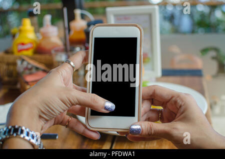 Woman hand shows mobile smartphone with white screen Stock Photo