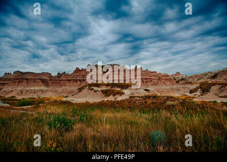 Landscape at sunset with cloud cover at Badlands National Park, South Dakota, USA Stock Photo