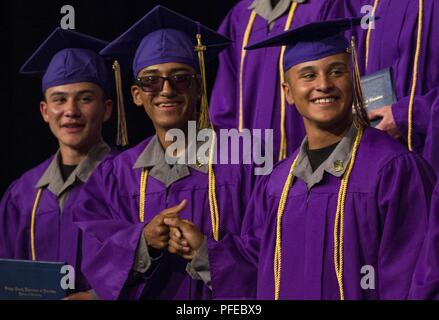 Sunburst Youth Challenge Academy Class 21 cadets bump fists after receiving their high school diplomas during the class commencement ceremony, June 9, 2018, in Los Alamitos, California. More than 150 cadets in the academy's 21st class walked the stage to receive certificates of completion for the 5.5 month residential phase of the 17.5 month National Guard Challenge Program. Residential phase graduates now enter into a yearlong mentorship phase to finish the program. Stock Photo