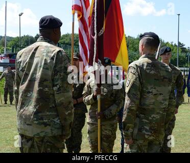 U.S. Army Sgt. First Class Cheryl Mays (center), Landstuhl Regional Medical Center (LRMC) color guard colors sergeant, prepares to hand the hospital   colors to Command Sgt. Maj. Clark Charpentier (right) during his relinquishment of responsibility ceremony on May 30, 2018 at Landstuhl/Germany Stock Photo