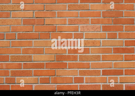 Flemish stretcher bond pattern brick wall background with weathered bricks in orange and yellow colors Stock Photo