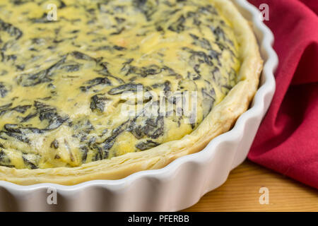 Spinach, eggs, feta tart very close up - Spinach quiche background with selective focus Stock Photo
