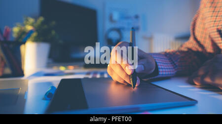 Graphic designer working on digital tablet. Photographer working at office. Stock Photo