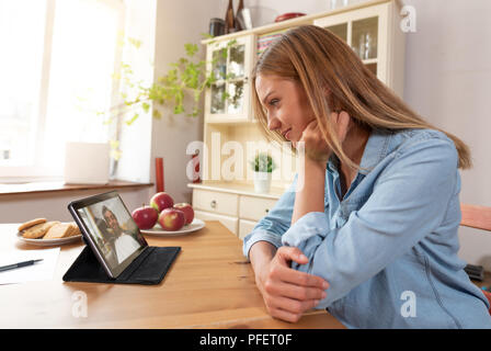 Woman talking with man through a video chat using a digital tablet Stock Photo