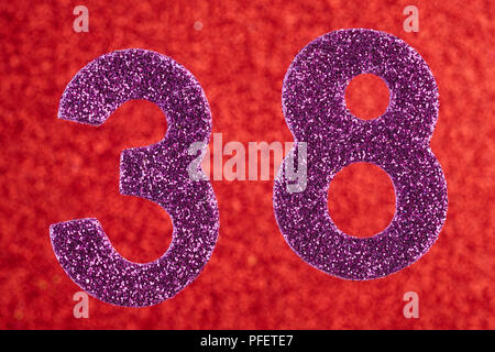 Number thirty-eight purple color over a red background. Anniversary. Horizontal Stock Photo