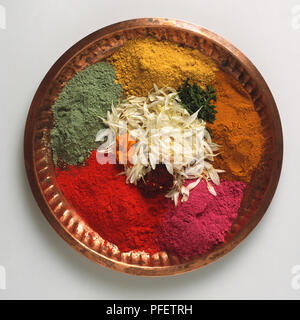India, colourful paint powders and flower petals used for Holi festival on brass tray. Stock Photo
