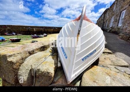 Rowing boat upside down in the Cornish fishing village of Mousehole,Cornwall,England,UK
