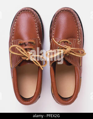 Pair of men's brown leather shoes with matching leather laces, view from above