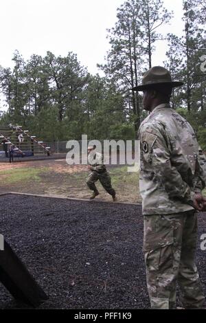 U.S. Army Reserve Spc. Nicolas Cholula-Lopez, representing, 311th Signal Command (Theater) charges toward next obstacle during the 2018 U.S. Army Reserve Best Warrior Competition at Fort Bragg, North Carolina,  June 12, 2018. The grueling, multifaceted competition evaluated U.S. Army Reserve Soldiers in the ruck march, the Excellence in Competition pistol range, the German Armed Forces Proficiency Badge and several other events with more challenges to come.  - ( Stock Photo