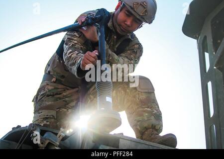 Sgt. Jhon Juen, Anaheim, California native, infantryman with 1st Squadron, 2nd Cavalry Regiment, maintains an Interim Armored Vehicle 'Stryker” during  a multinational quick response exercise, Bull Run 5.5, with Battle Group Poland at Bemowo Piskie Training Area, Poland on June 10, 2018. This year's exercise, which runs from June 3-15, tests allies and partners from 19 countries on their ability work together to deter aggression in the region and improve each unit's ability to perform their designated mission. Stock Photo