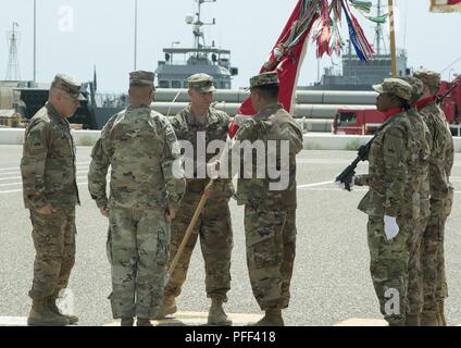 U.S. Army Lt. Col. Rob Newbauer, commander of the 40th Brigade Engineer Battalion, 2nd Brigade Combat Team, 1st Armored Division, passes the battalion colors to Master Sgt. Martin Pelayo, the custodian of the colors, during a change of command ceremony at  Kuwait Naval Base, Kuwait, June 14, 2018. Newbauer succeeds Lt. Col. David Noble as the Battalion Commander. Stock Photo