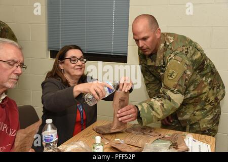 U.S. Army Capt Jay Sheldon, second from right, stands with Tyler Hankla ...