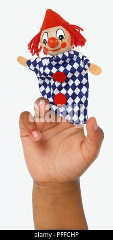 Clown finger puppet on childs hand, front view. Stock Photo