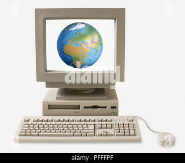 Computer keyboard, processor, monitor and mouse, with monitor showing map of the globe. Stock Photo