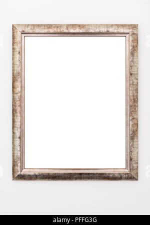 empty ornate picture frame hanging on wall Stock Photo