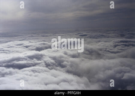 Aerial view of stratocumulus, mass of white fluffy clouds, viewed from above, picture taken from aeroplane. Stock Photo