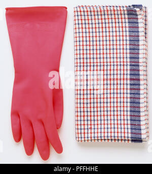 Pink rubber glove and folded tea towel Stock Photo