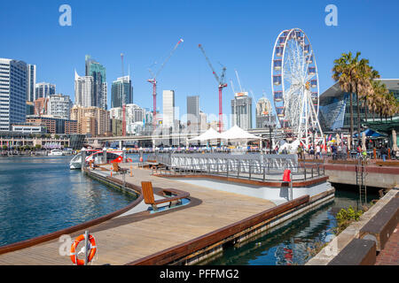 Ferris wheel in Darling harbour and Sydney city centre skyline,New South Wales,Australia Stock Photo