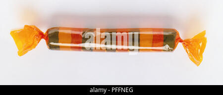 Packet of colourful, round sweets wrapped in clear cellophane. Stock Photo