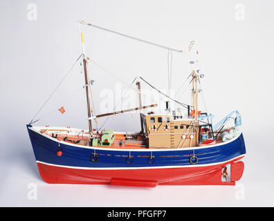 Red and blue fishing boat with nets and a winch at the rear Stock Photo -  Alamy