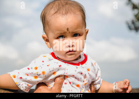 Kathmandu,Nepal - Aug 17,2018: Portrait of  a curious asian baby lookinng at the camera.Photographed in Kathmandu Nepal. Stock Photo