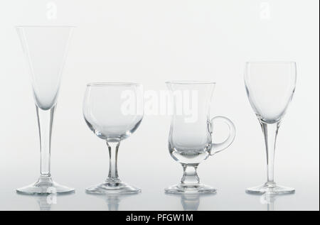 Four different drinking glasses in a row Stock Photo