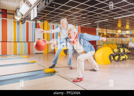 Cheerful nice elderly men having fun together Stock Photo