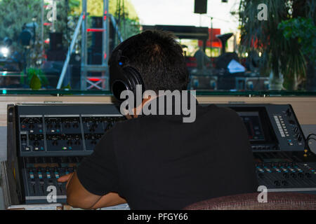 man stage sound mixer at sound engineer hand using audio mix .Voice control and live broadcast Concerts concept. Stock Photo